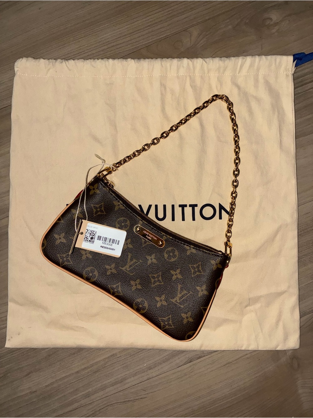 Louis Vuitton monogram shoulder bag with gold-tone chain strap.